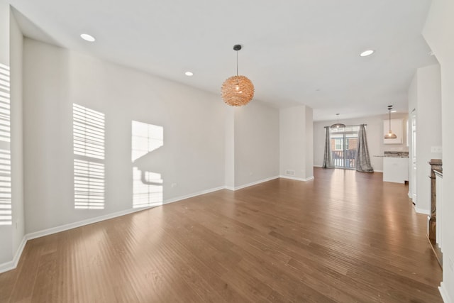 unfurnished living room with dark wood-type flooring