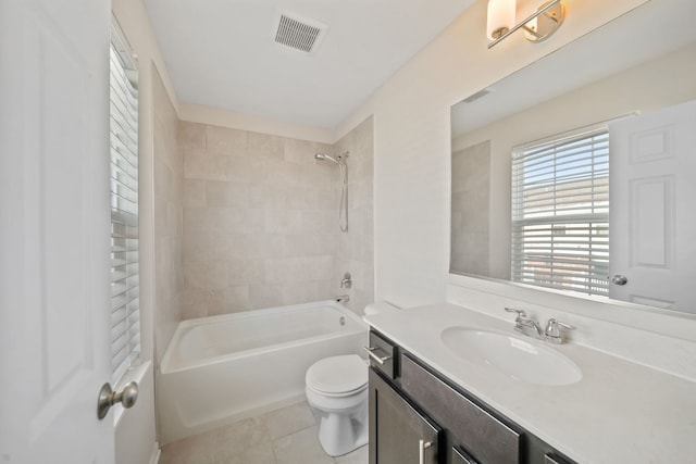 full bathroom with toilet, tiled shower / bath combo, tile patterned floors, and vanity