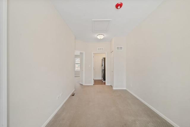 hall featuring light colored carpet