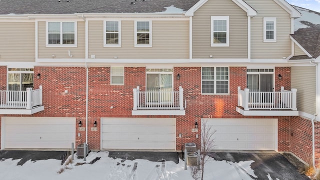 snow covered property featuring central air condition unit