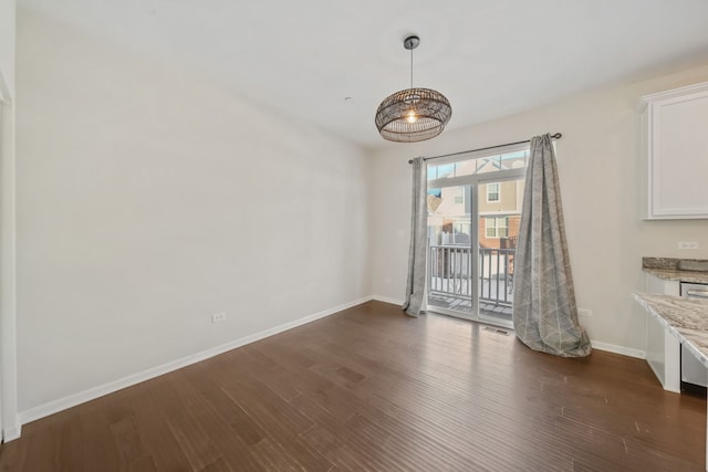 unfurnished dining area featuring dark wood-type flooring