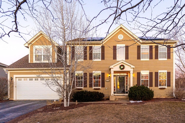 colonial inspired home with a garage