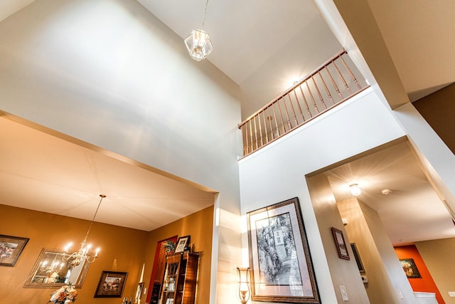 stairs featuring a chandelier