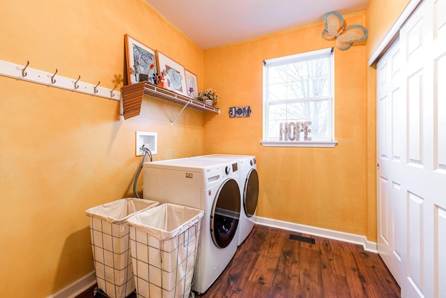 laundry room with dark hardwood / wood-style floors and washing machine and clothes dryer