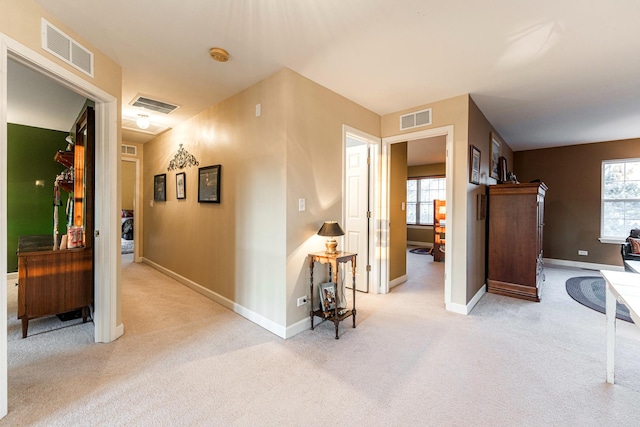 hallway with light colored carpet