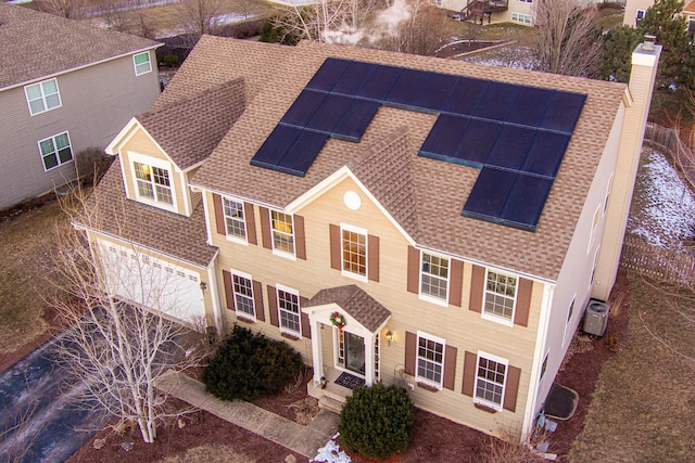 view of front facade featuring central AC unit and solar panels