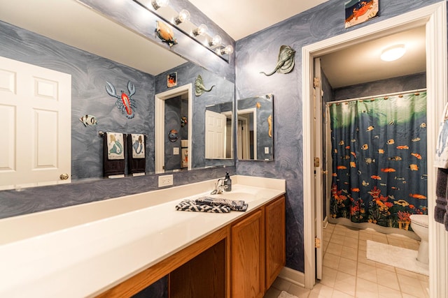 bathroom with curtained shower, toilet, vanity, and tile patterned flooring