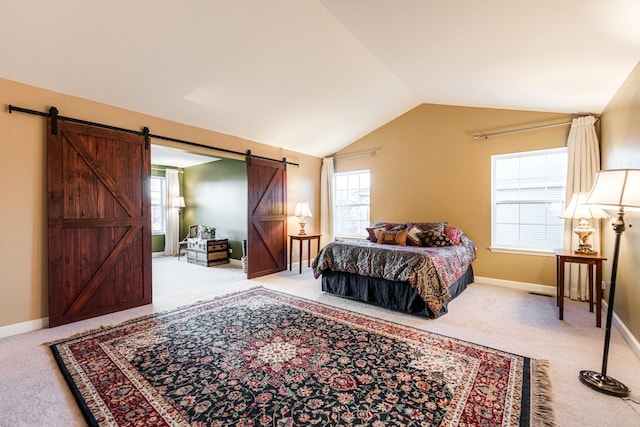 bedroom featuring carpet floors, multiple windows, a barn door, and vaulted ceiling