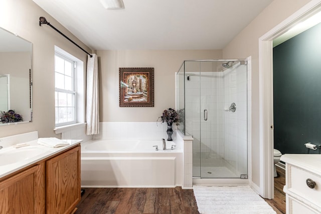 full bathroom with vanity, toilet, shower with separate bathtub, and hardwood / wood-style flooring