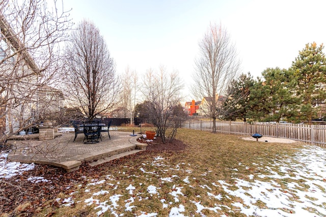 snowy yard with a patio area