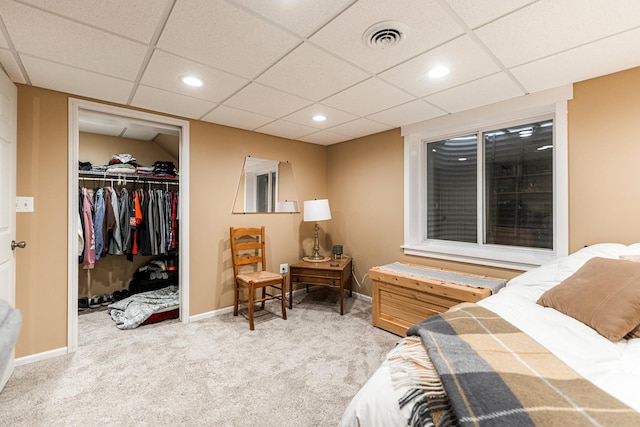 carpeted bedroom featuring a spacious closet and a closet