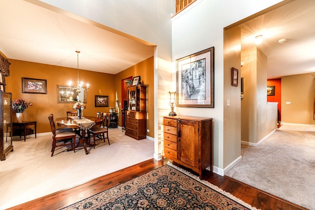 dining area with hardwood / wood-style floors and a chandelier