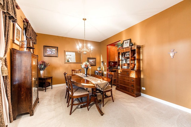 carpeted dining room with a chandelier