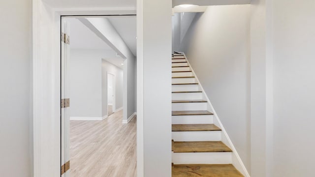 stairway with hardwood / wood-style flooring