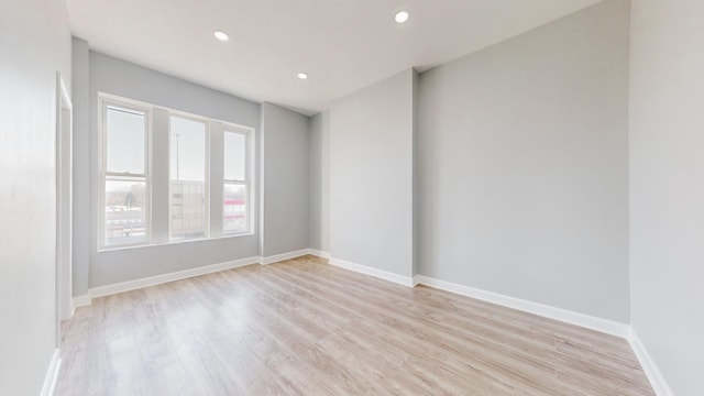 unfurnished room with light hardwood / wood-style floors