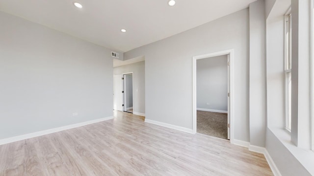 unfurnished room with light wood-type flooring