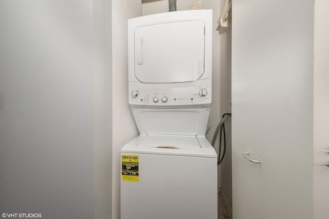 laundry room featuring stacked washer and dryer and laundry area