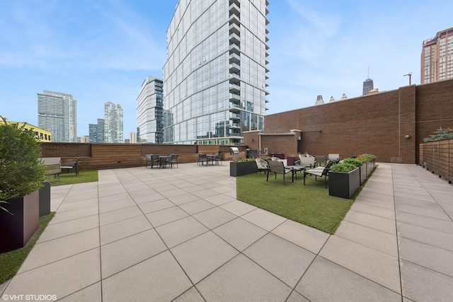 view of patio / terrace featuring a city view and an outdoor living space