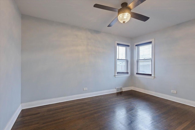 unfurnished room with ceiling fan and dark hardwood / wood-style floors