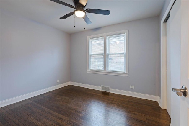 empty room featuring ceiling fan and dark hardwood / wood-style floors