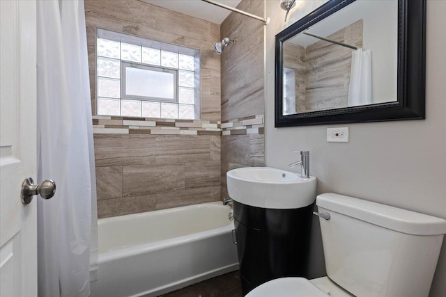 bathroom with toilet and shower / bath combo with shower curtain