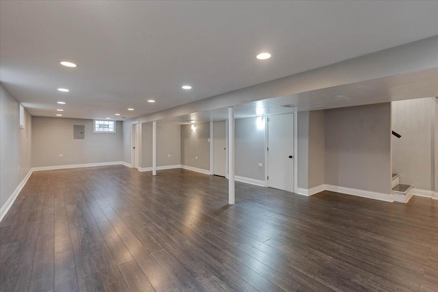 basement with dark hardwood / wood-style floors