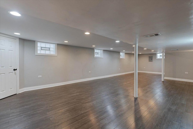 basement with dark hardwood / wood-style floors