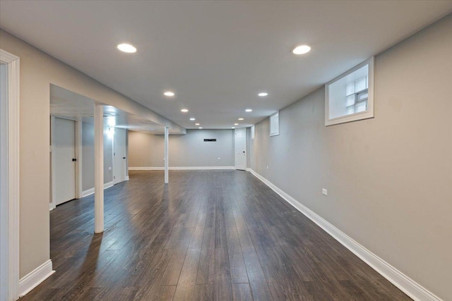 basement with dark hardwood / wood-style floors