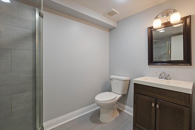 bathroom featuring a shower with door, tile patterned flooring, vanity, and toilet