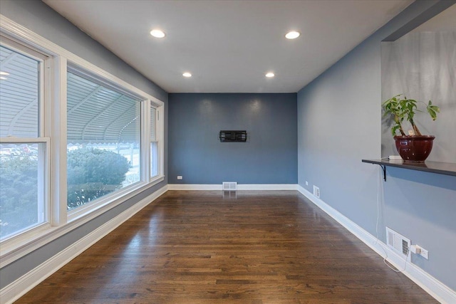 unfurnished room featuring dark wood-type flooring