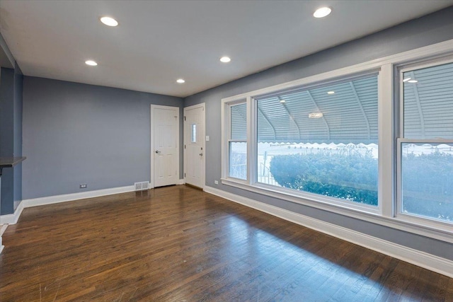 unfurnished living room featuring dark wood-type flooring