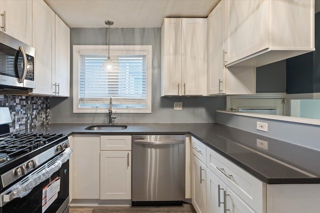 kitchen with white cabinets, appliances with stainless steel finishes, and sink