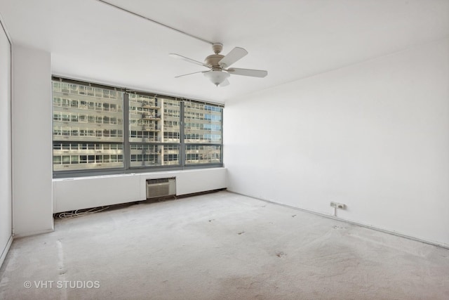 empty room featuring ceiling fan and a wall unit AC