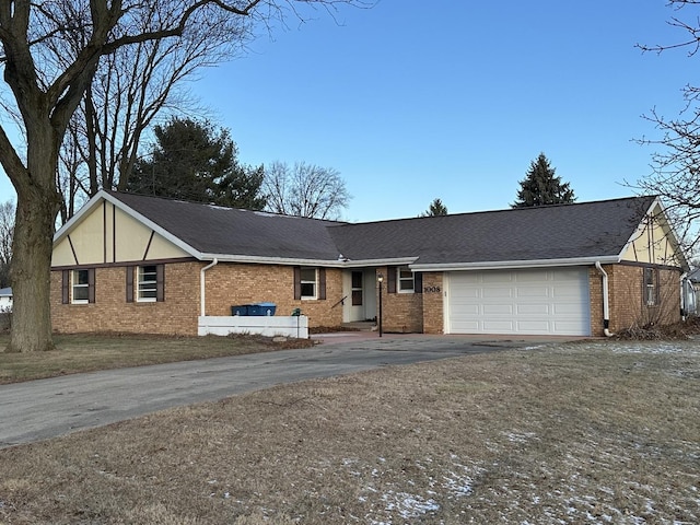 view of front of home with a front yard and a garage