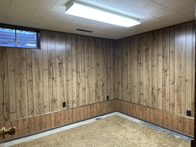 basement with wood walls and carpet