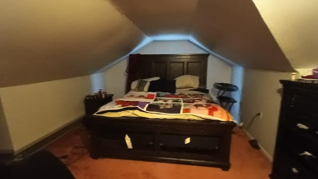 bedroom featuring lofted ceiling and carpet