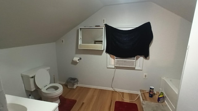 bathroom with hardwood / wood-style floors, toilet, vanity, cooling unit, and lofted ceiling