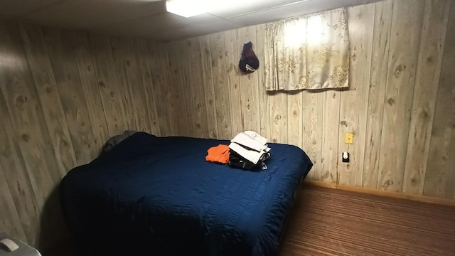 bedroom featuring wooden walls