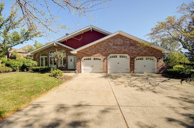 view of front of property with a garage and a front lawn