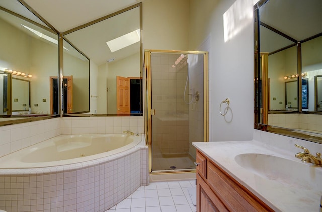 bathroom with vanity, tile patterned floors, vaulted ceiling with skylight, and separate shower and tub