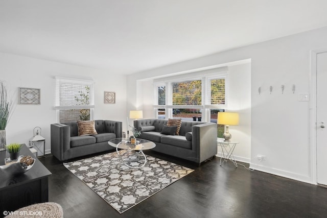 living room featuring a wealth of natural light and dark hardwood / wood-style floors