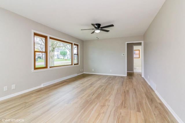 unfurnished room with light wood-type flooring and ceiling fan