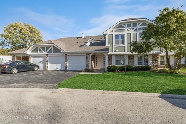 view of front of property with a garage and a front lawn