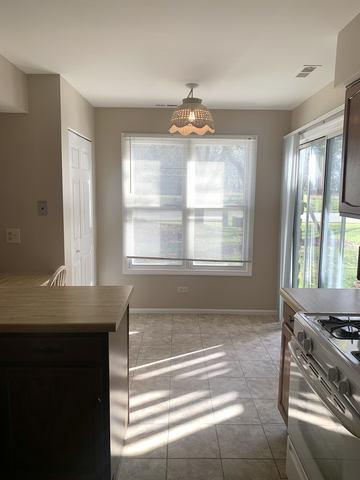 kitchen with light tile patterned floors and stove