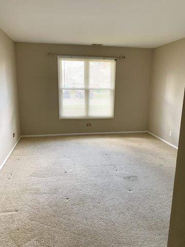 spare room featuring light carpet