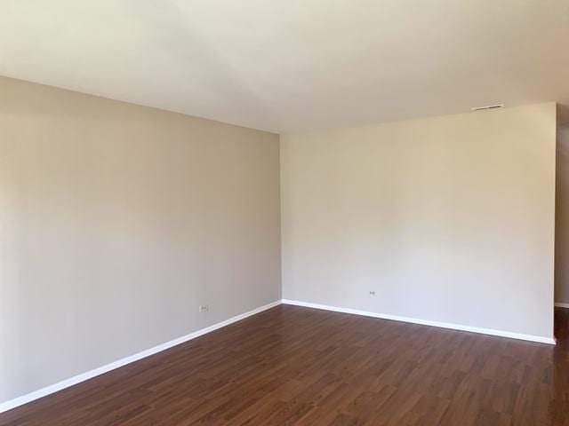 spare room featuring dark hardwood / wood-style floors