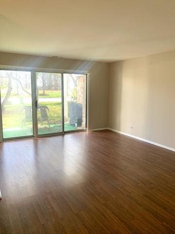 unfurnished room with dark hardwood / wood-style floors