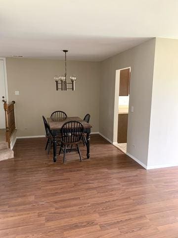 dining area with a chandelier and wood-type flooring