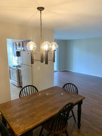 dining space featuring an inviting chandelier and light hardwood / wood-style flooring