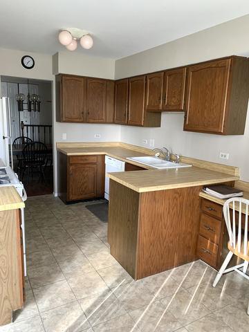 kitchen with sink, dishwasher, stove, and kitchen peninsula